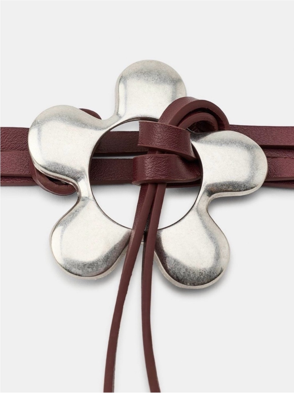 Zara dark red faux leather belt with silver flower buckle. Size US 32.